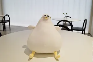 Detail shot of a cute fat white Danish seagull plush toy sitting on a minimalist table