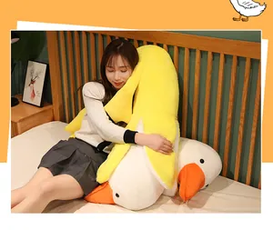 Girl hugging a giant banana duck plush pillow on a wooden bed in a cozy bedroom