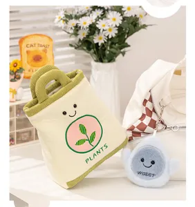 Close-up detail of plush watering can and water drop toy with cute smiley faces