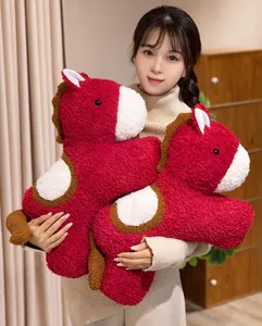 Detail view of a soft red plush horse toy held by an Asian model for 2026 mascot