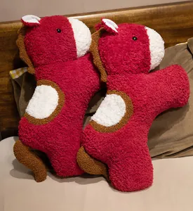 Close-up of two red horse plush pillows with soft sherpa texture for 2026 mascot