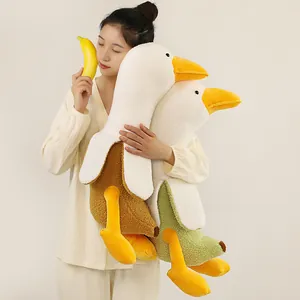 Creative banana duck plush toy long pillow held by model in soft lighting environment