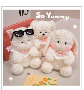 Close-up of three cute white plush animals featuring a bear and bunny with bibs.