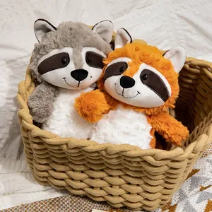 Adorable plush raccoon and fox stuffed animal set in a cozy woven basket