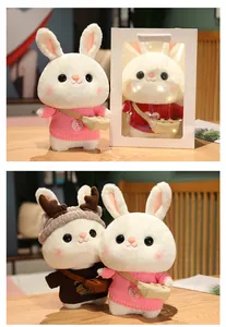 Close-up of cute white rabbit plush toys in colorful sweaters with gift packaging