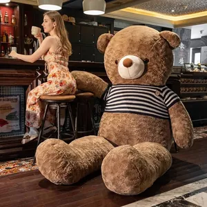 Giant brown teddy bear plush toy wearing a classic navy striped sweater