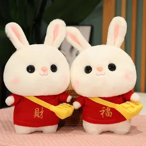 Pair of cute white rabbit plush toys wearing red sweaters with festive embroidery.