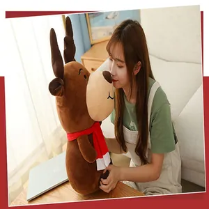 Asian model holding a soft brown Christmas reindeer plush toy with a red scarf detail