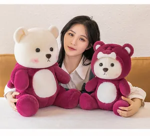Young woman holding two sizes of burgundy and white plush teddy bears as sweet gifts.