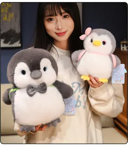 Adorable gray and white plush penguin stuffed animals displayed in two different sizes