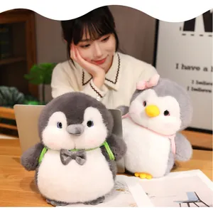 Detailed view of two adorable chubby penguin plush dolls in a warm home setting