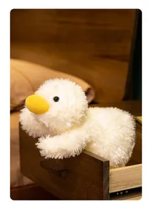 Detailed macro view of a soft white plush duck toy peeking out from a wooden drawer