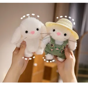 Close-up pair of cute gardener bunny plush dolls with straw hat and green overalls