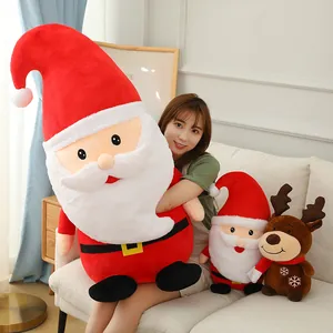 Large Santa Claus and reindeer plush toys being held by a model for a festive Christmas gift