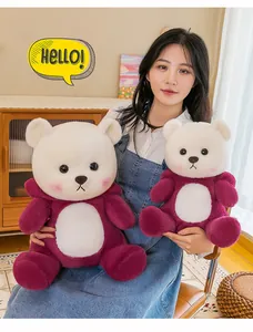 Close-up detail of two cute red and white teddy bear plush toys in different sizes.