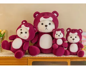 Group of strawberry themed teddy bear plush toys in various sizes on a wooden table