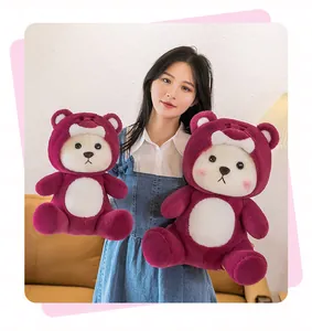 Young Asian woman holding two cute red strawberry bear plush toys for Valentine gift.