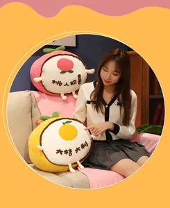 Asian model holding cute fruit-shaped plush pillows with Chinese embroidery detail