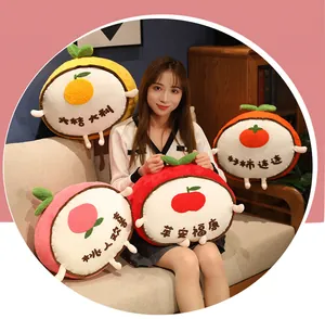 Detail of fruit-themed plush pillows with Chinese characters held by an Asian model