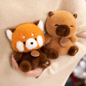Cute Red Panda and Capybara plush toys held in hands for size reference