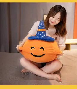 Soft Halloween pumpkin plush pillow with wizard hat held by a model in a bedroom