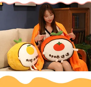 Detail view of the cozy 3-in-1 orange persimmon plush pillow with matching soft blanket.