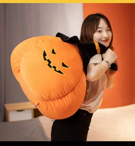 Soft large Halloween pumpkin plush pillow with wizard hat shown in a cozy home setting