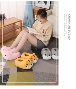 Lifestyle detail of cartoon hamster and tiger plush slippers in a cozy living room