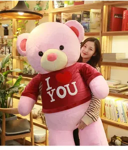 Close-up of a giant pink teddy bear in a red I Love You sweater, perfect for gifts.