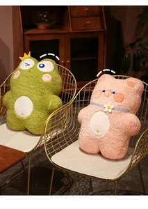 Detail of soft plush frog and pig pillows on stylish gold wire chairs for office napping