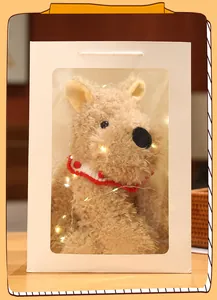 Detailed view of a West Highland terrier plush toy in a white gift bag with lights