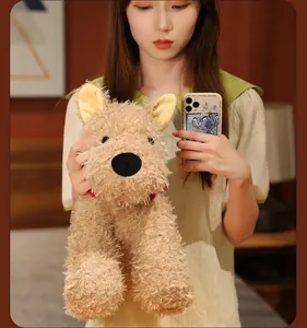 Adorable fluffy West Highland Terrier plush toy dog held by a person in a cozy room