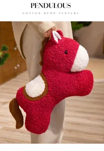 Detail of red plush horse toy with sherpa texture and white accents.