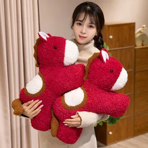 Cute red pony plush toy Year of the Horse mascot pillow held by a female model