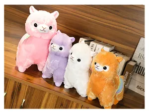 Group of colorful alpaca plush toys in pink purple white and orange on a shelf