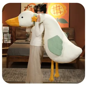 Large soft plush duck body pillow held by model in a cozy bedroom setting
