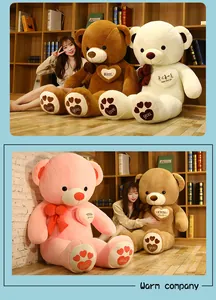 Giant plush teddy bears in pink, white, and brown colors with heart details and cozy scarves