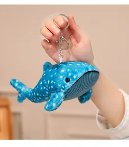 Detailed view of a blue whale shark plush keychain with soft spotted fabric