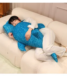 Detailed view of a soft blue whale shark plush toy being used as a sleep pillow