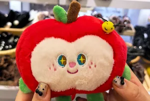 Detailed view of a cute red apple plush toy charm with embroidered star eyes