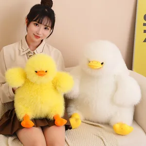 Two cute fluffy long-haired duck plush toy pillows in yellow and white being held