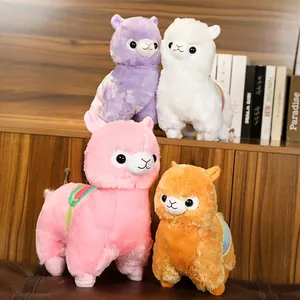 Group of adorable colorful alpaca plush toys with rainbow saddles displayed on a shelf