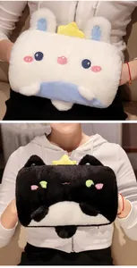Detail view of cute cartoon plush hand warmer pillows in black and white styles
