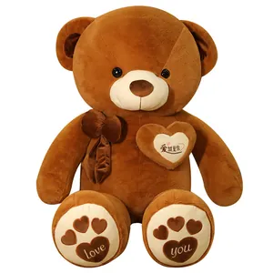 Large brown plush teddy bear with embroidered heart and bow decoration