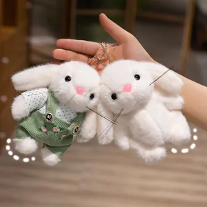 Pair of cute white long-eared bunny plush dolls with green gardener outfit