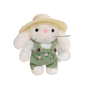 Adorable gardener bunny plush toy wearing a straw hat and green floral overalls