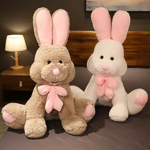 Set of large long-eared rabbit plush toys in brown and white colors with pink bows