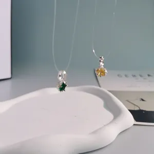Close-up detail of dopamine style colorful crystal pendants in green and amber.