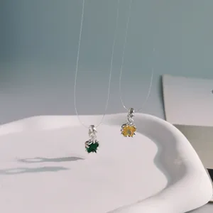 Detailed macro view of colorful crystal star pendants featuring green and yellow gemstones
