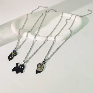 Vista detallada de collares con colgantes de gato de dibujos animados en acero titanio